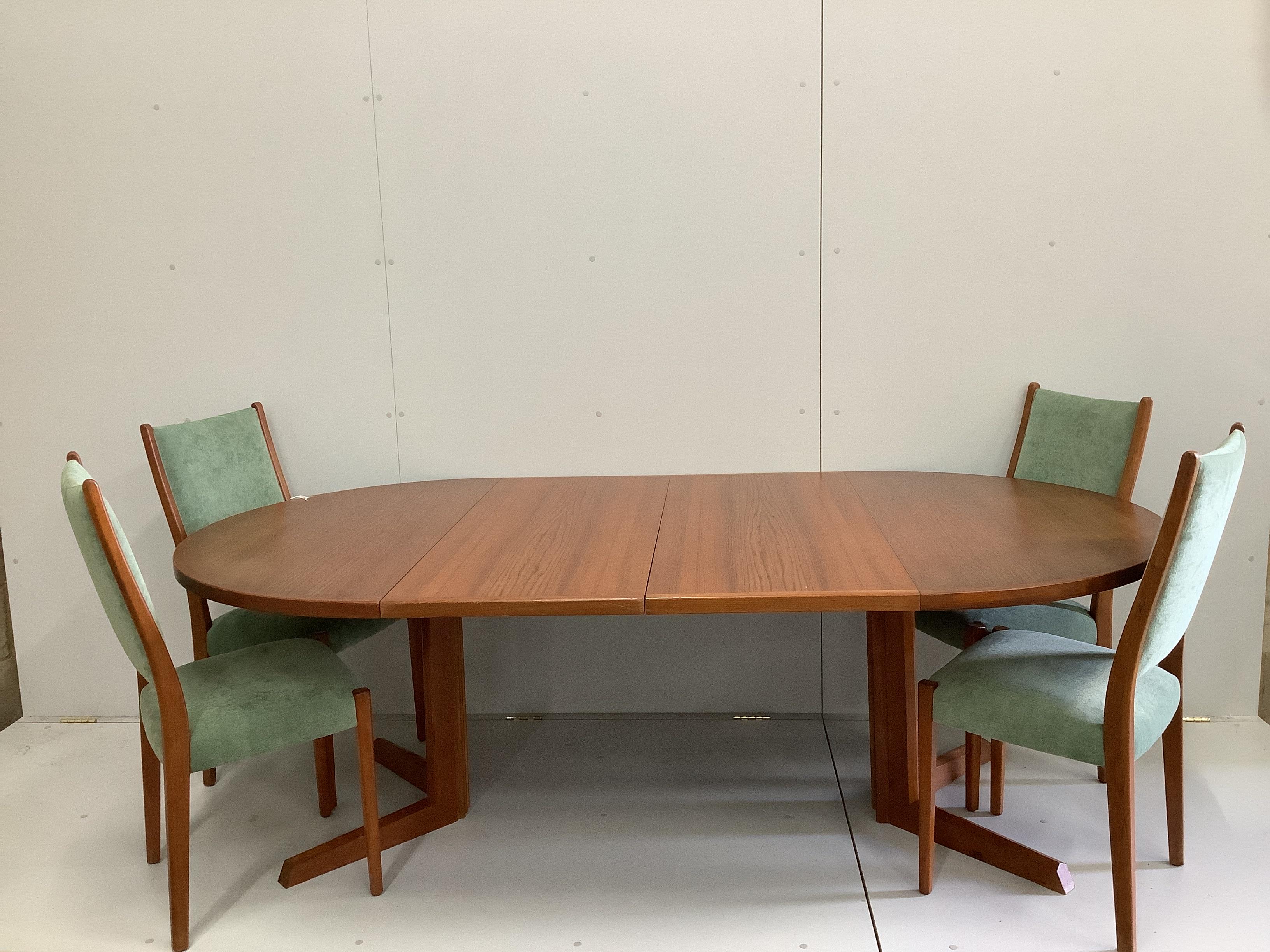 A Gudme Mobelfabrik mid century teak extending dining table, 220cm extended, two spare leaves, depth 122cm, height 73cm and four chairs